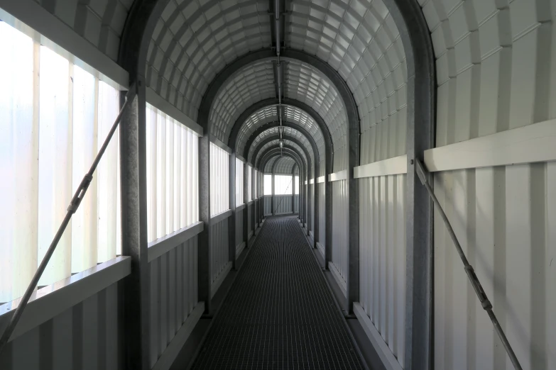 a hallway with windows leading to other buildings