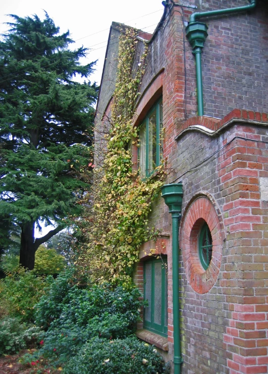 a big brick building with lots of plants in front of it