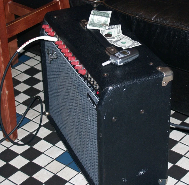 a speaker and a bunch of money on a floor