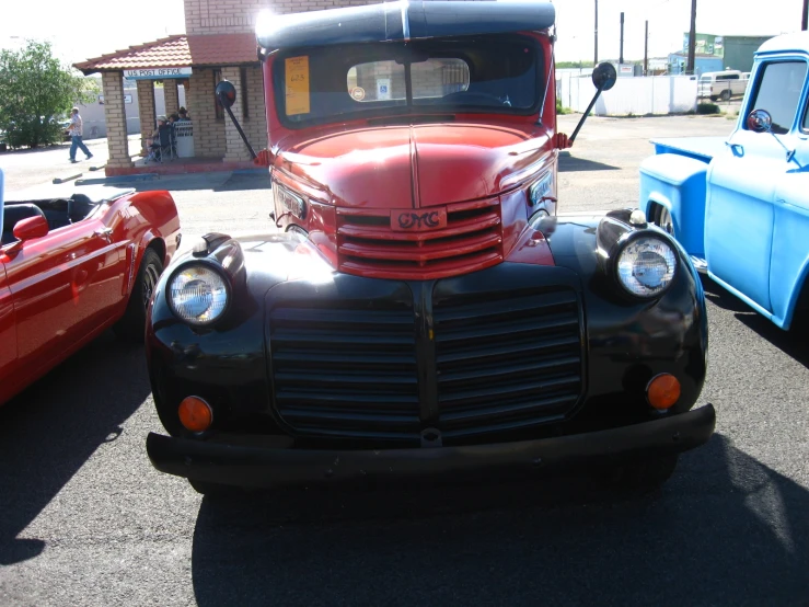 an old pick up truck is parked in a parking lot