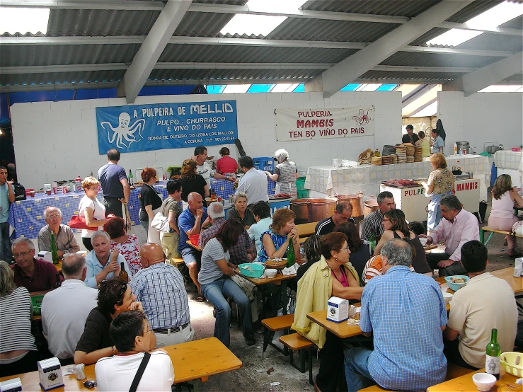 a group of people eating at tables and talking