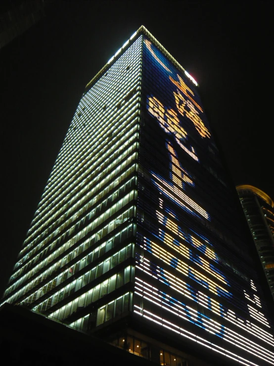a very tall building with lit up numbers and letters on the side