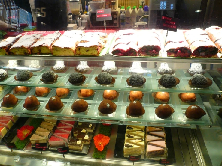 there is a display case full of many different desserts