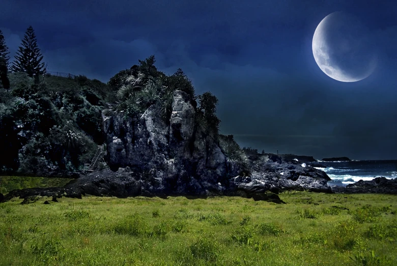 a full moon is seen over some rocky cliffs