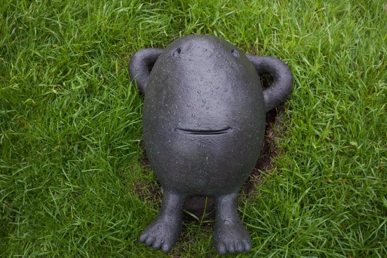 this is a toy in the grass that looks like a monster