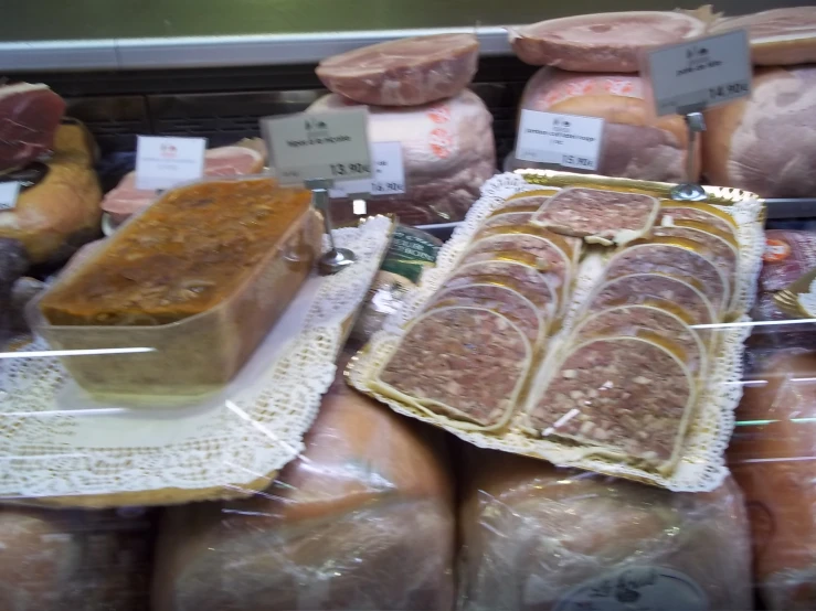 different kinds of sausage on display at a butcher shop