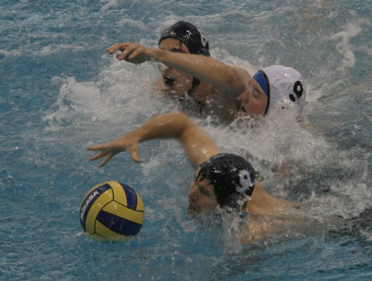 two swimmers playing in the water with one another