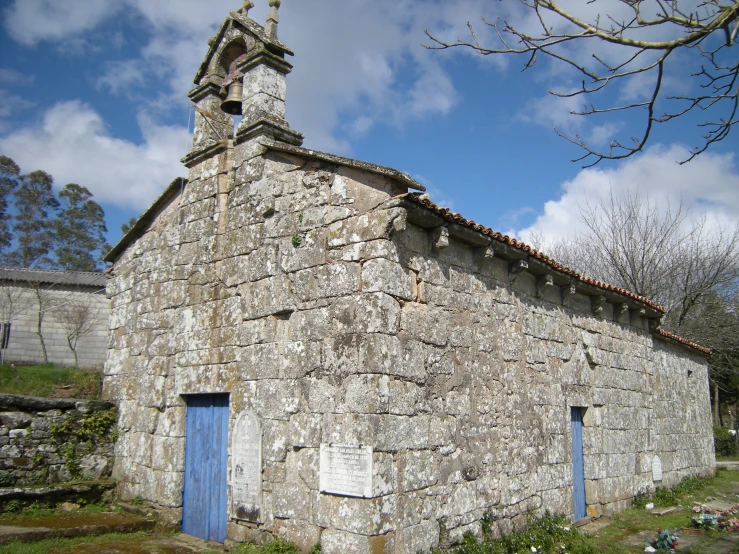 this is an old stone building with blue doors