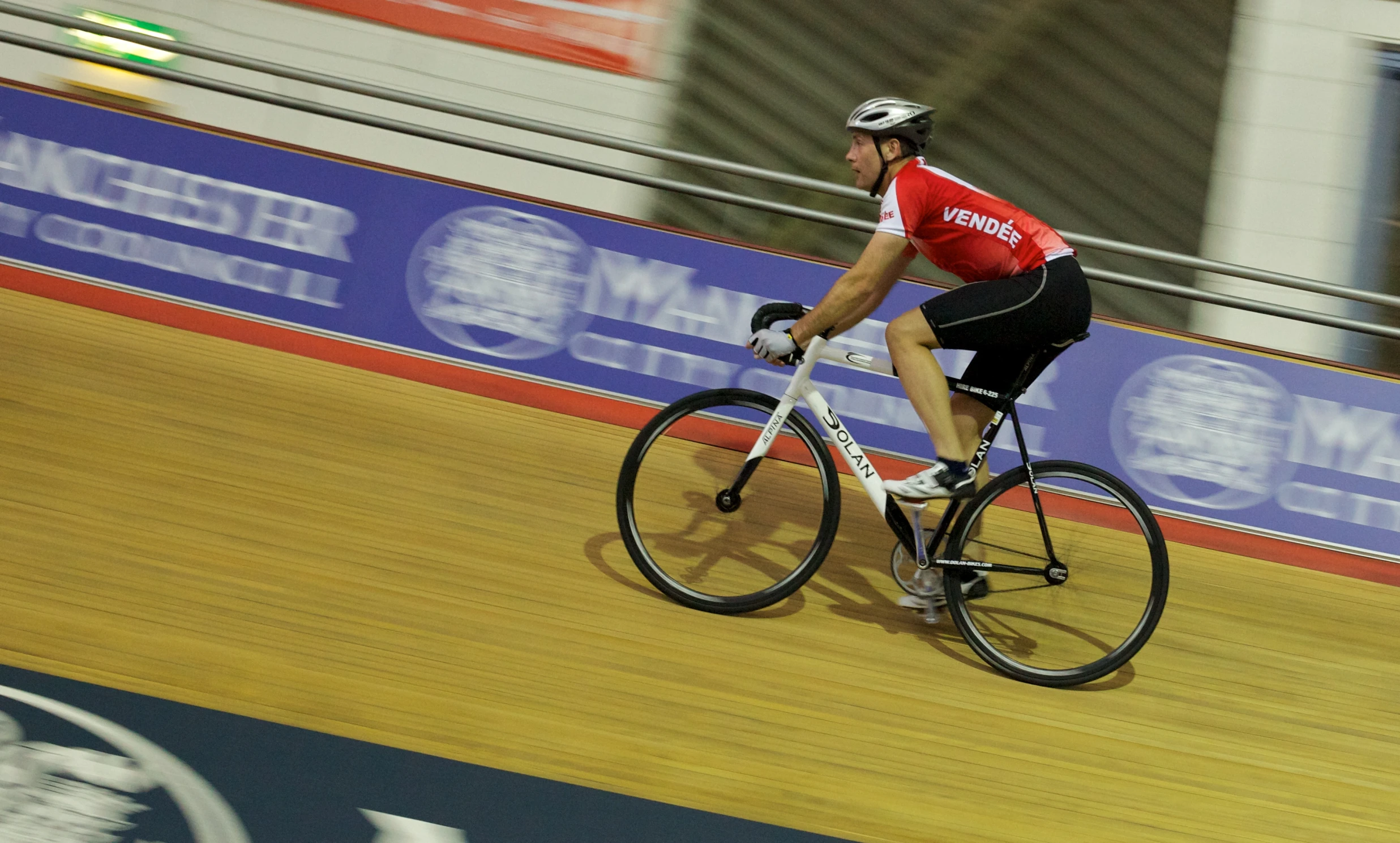 a man riding a bike through a track