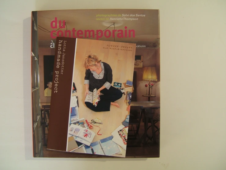 a magazine with an image of a woman sitting on the ground