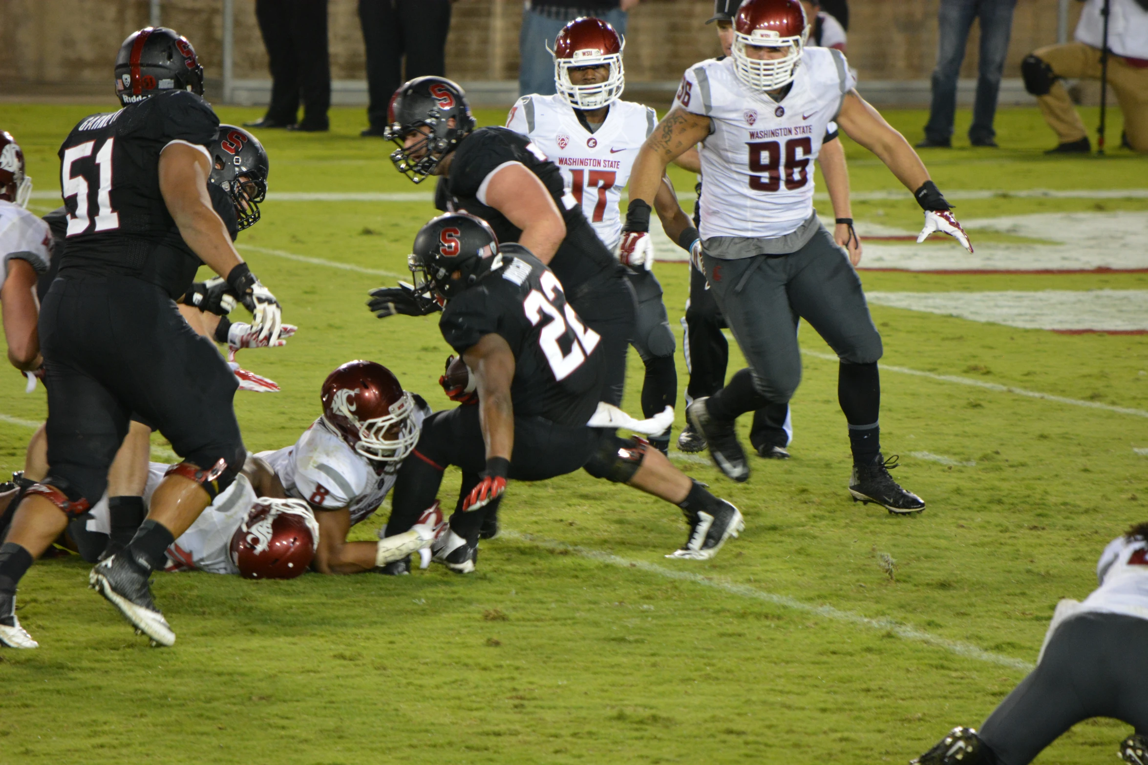 two football players are running the ball in a game