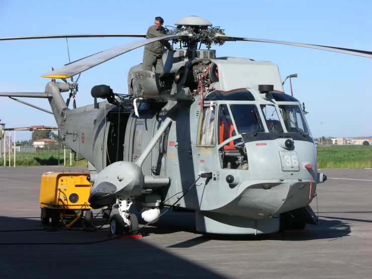 a helicopter with an extended pilot is being fitted