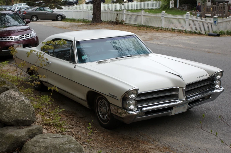 an old car that is parked in the street