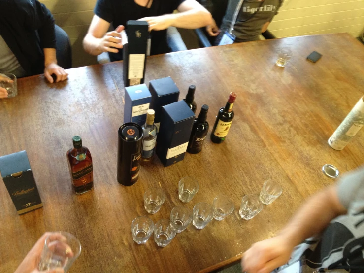 some people sitting around a table and drinking wine