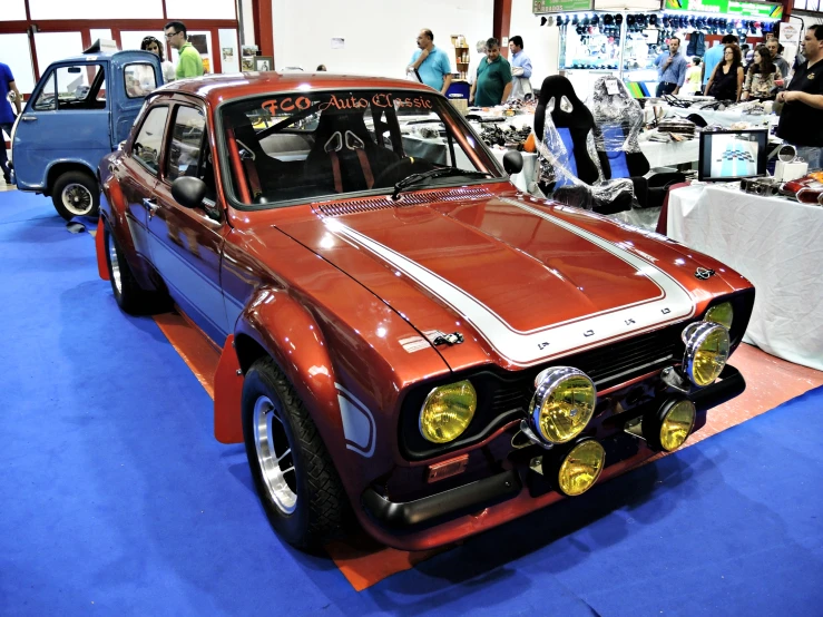 old and nice cars are on display in a convention