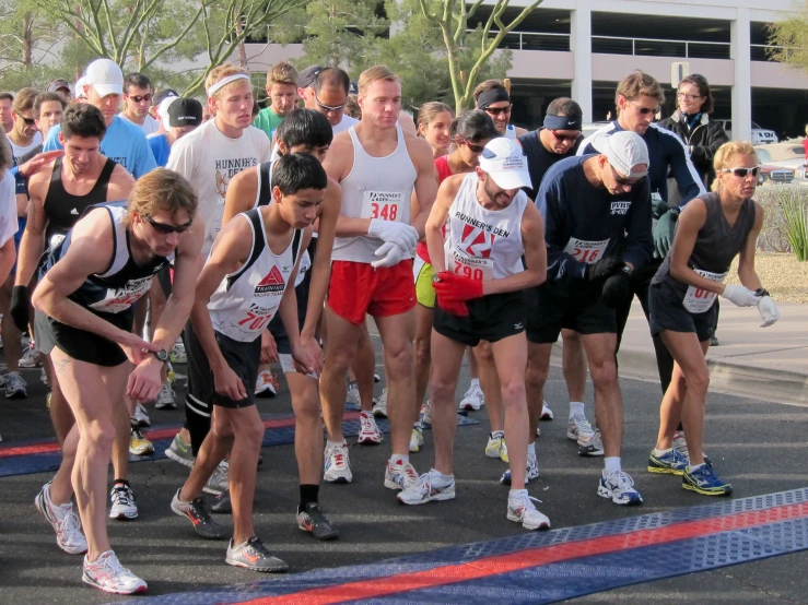 a group of people are watching some other runners