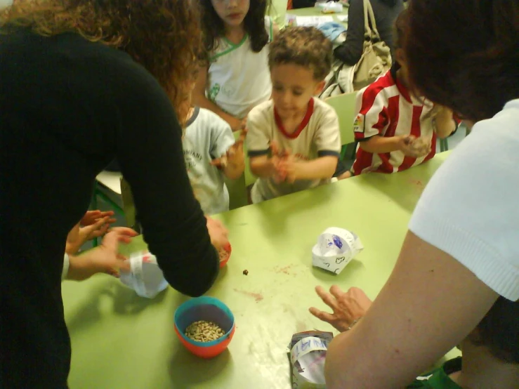 a lady with her hands together as she sits at a table