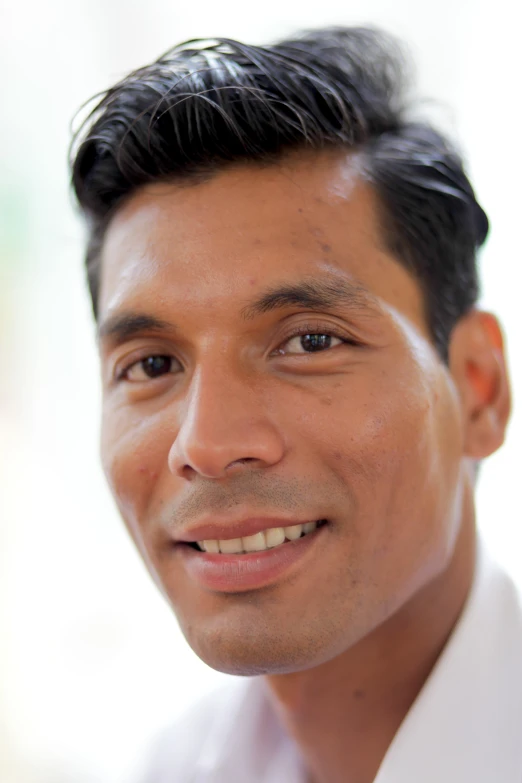 a man wearing a white dress shirt, and looking away from the camera