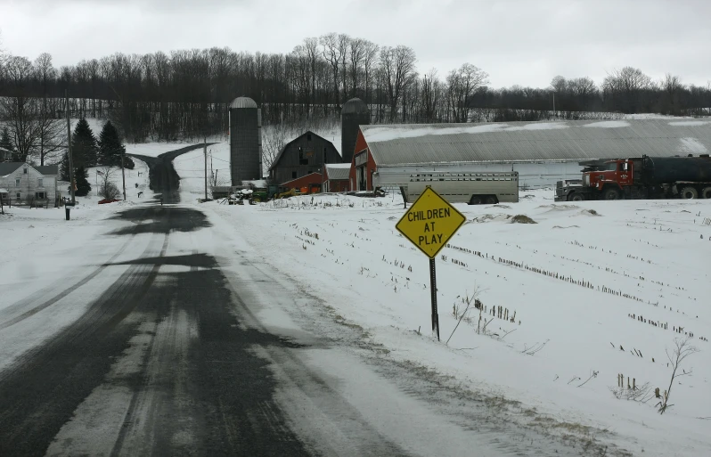 a road near some houses covered in snow