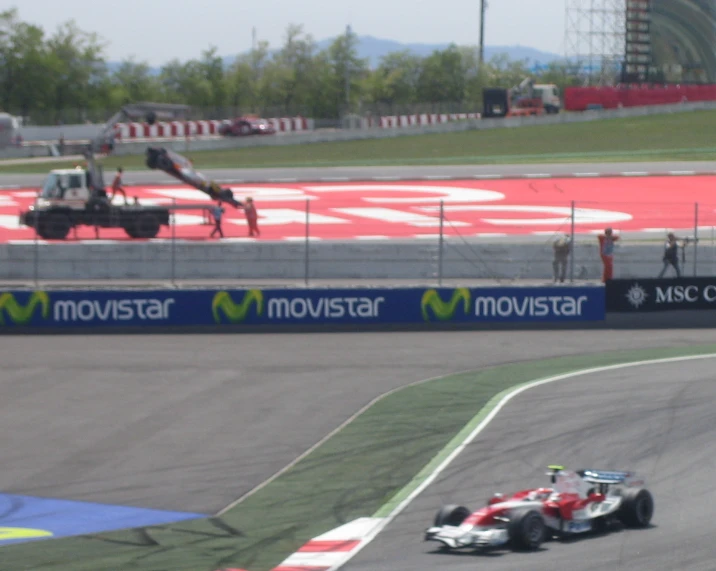 a racing car speeding along a racetrack near another car