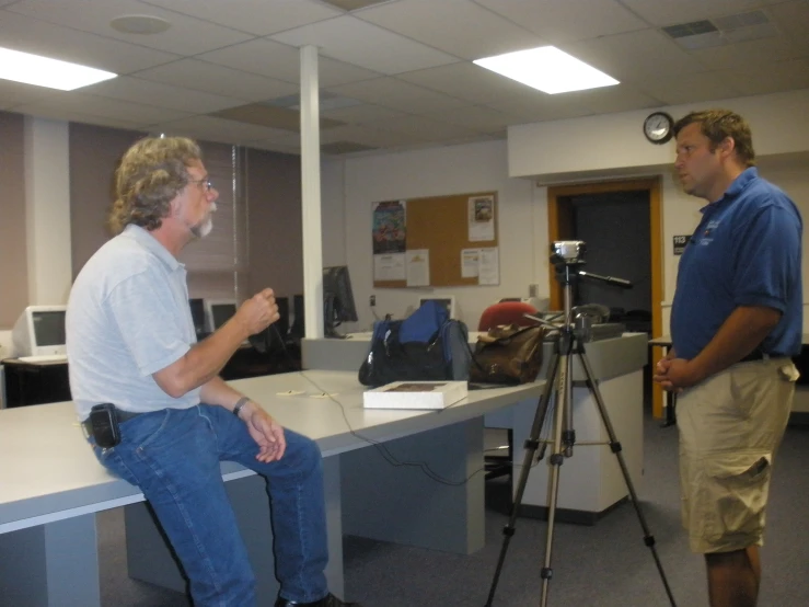 two people that are on the television set