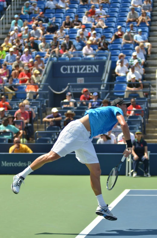 a male tennis player in action on the court