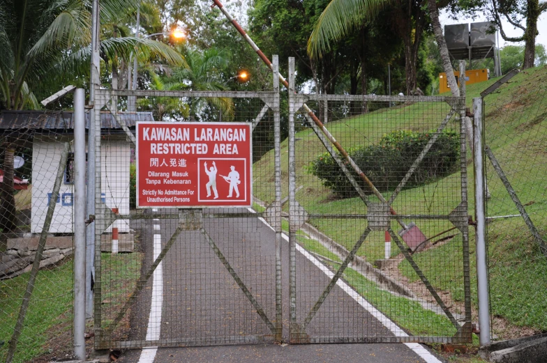 a sign warning people not to walk down the path