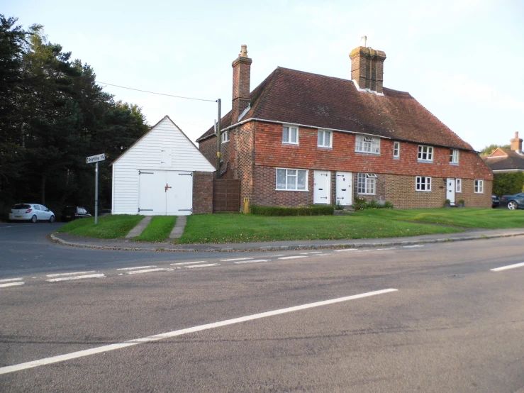 a three - bedroom building with two garages on the corner