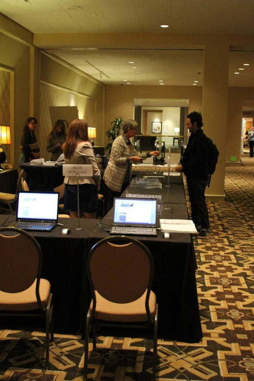 a large room with two laptops on tables