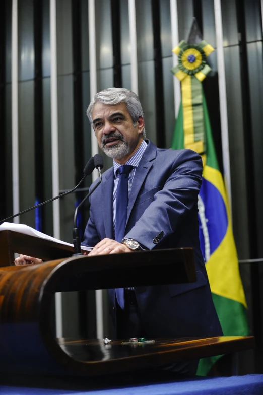 a man standing at a podium giving a speech