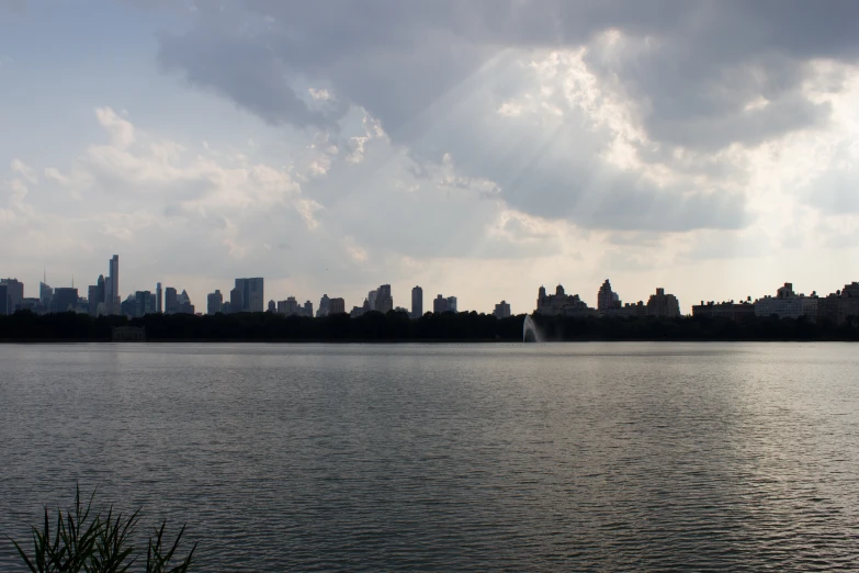 a lake with water in front of a city skyline