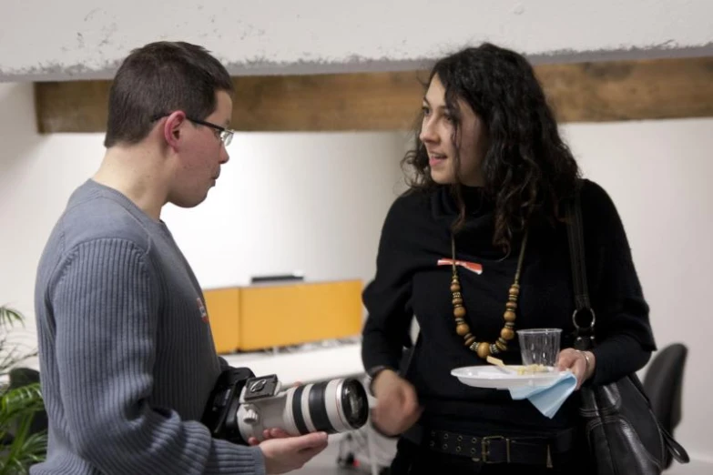 a couple of people in a room with a camera