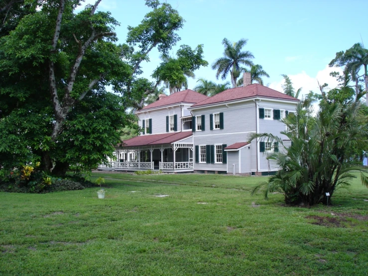 a big house sitting in a lush green field