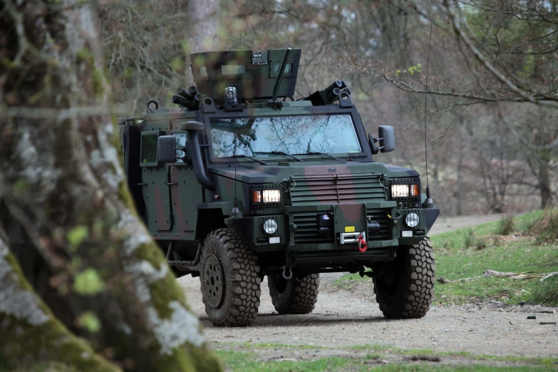 a military vehicle driving through the forest