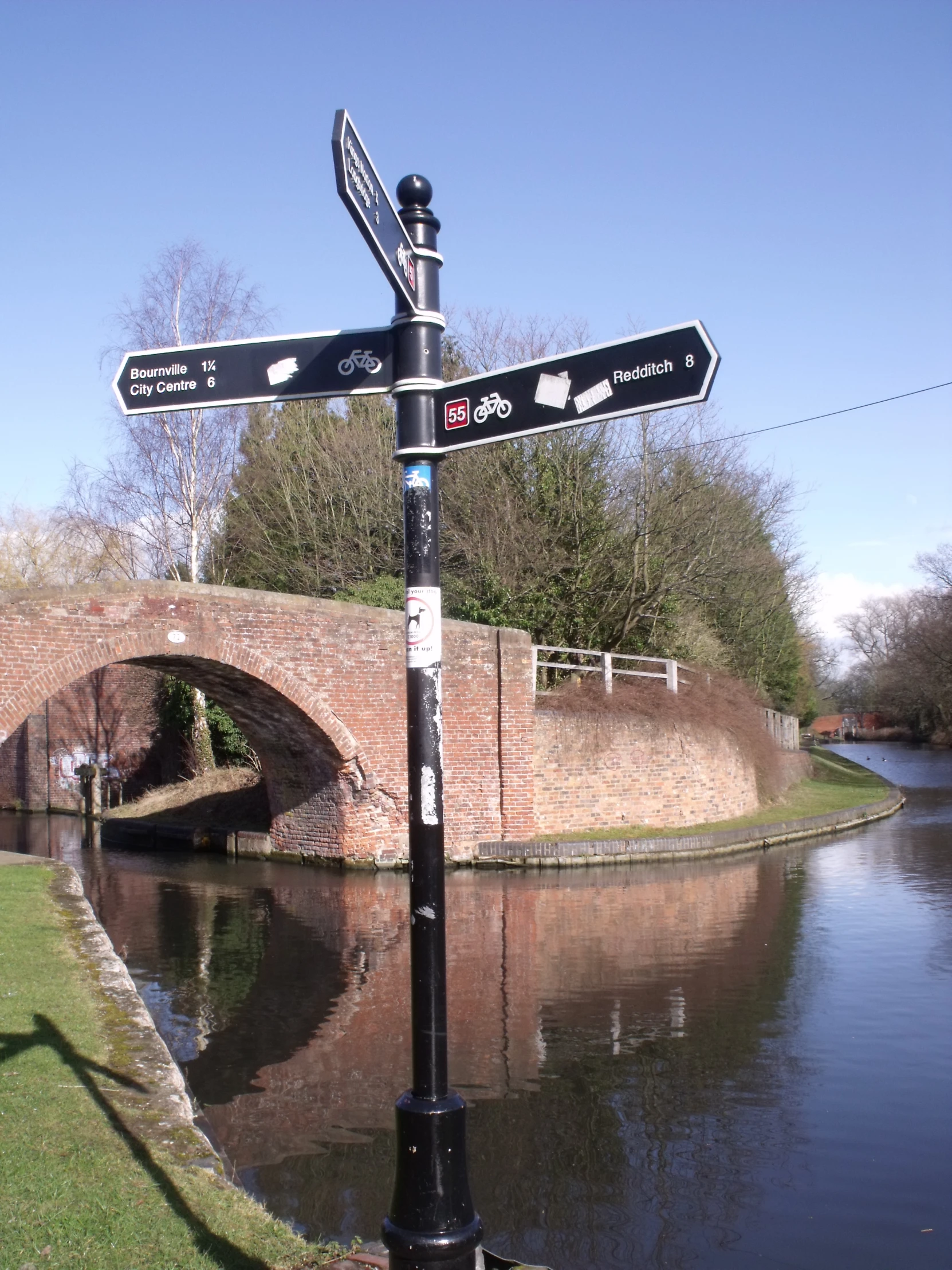 a street sign is hanging from a black pole