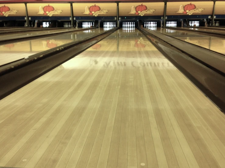 the bowling lanes in a bowling alley are brown