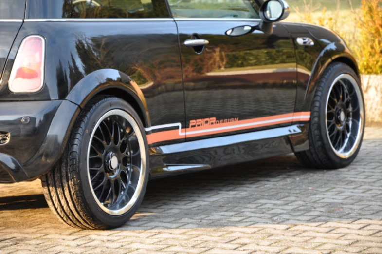 a mini car that has been painted with orange stripes