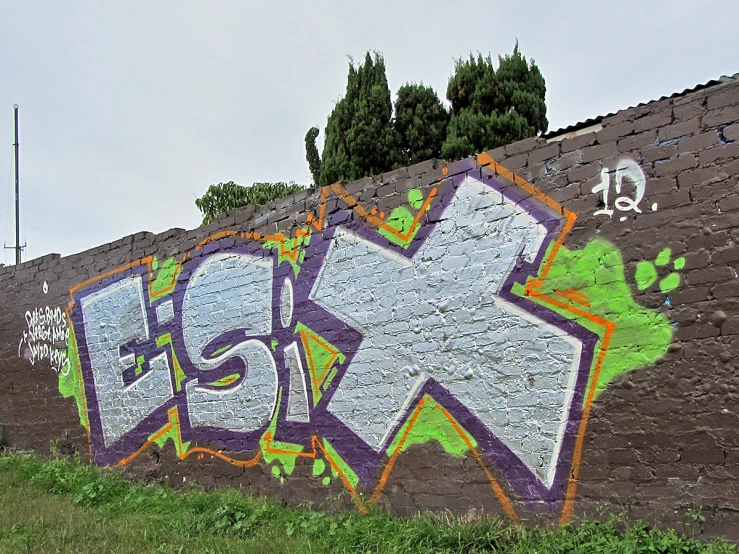 a brick wall with a graffiti on it