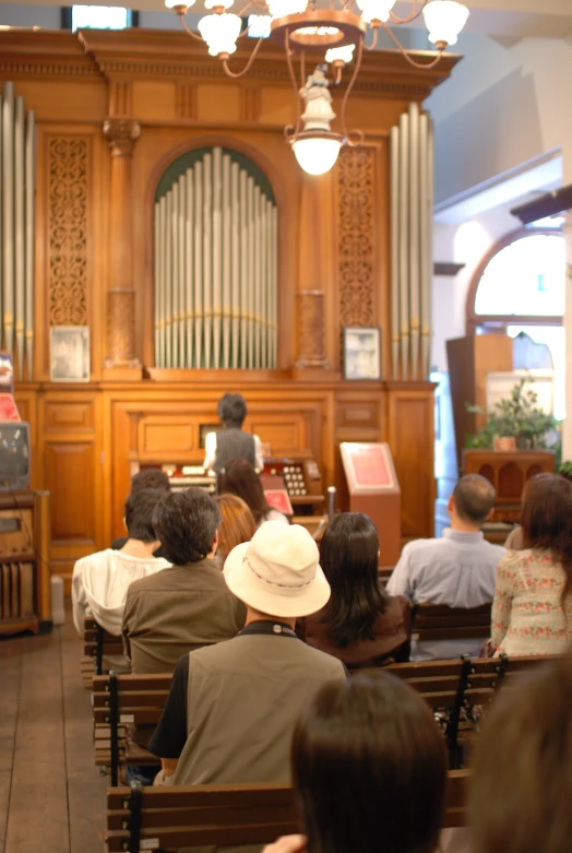 some people are sitting in chairs in a church