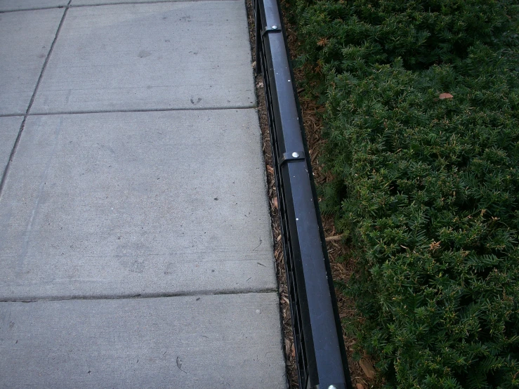 black rail lines along the curb near a sidewalk