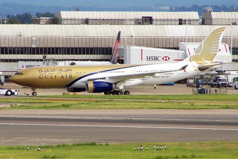 an airplane parked at the runway and in front of the terminal