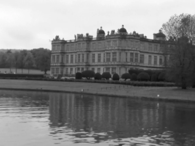 a lake next to a large stone building