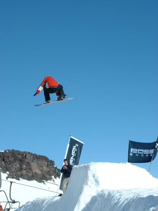 a man is flying through the air while riding a snowboard