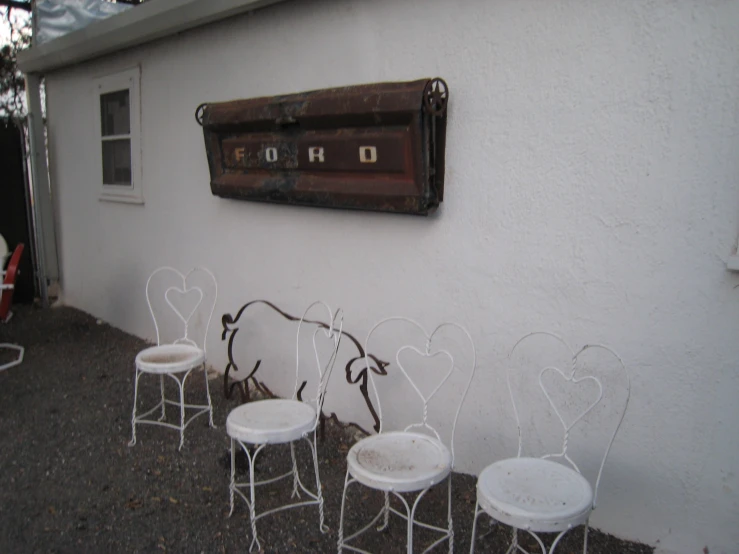 there are lots of white chairs lined up outside