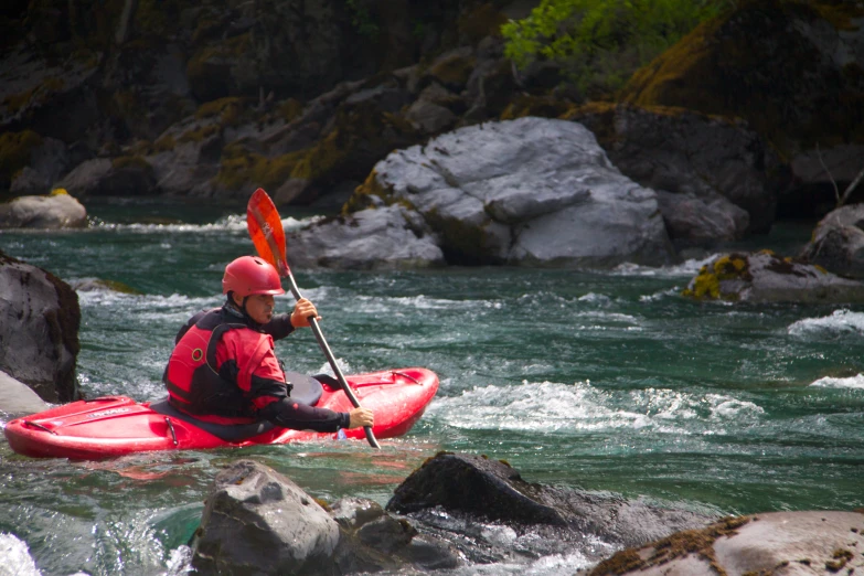 a man that is in some water with a kayak