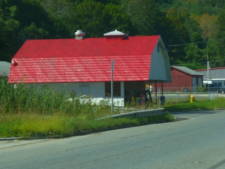 a red roof sits over an old house