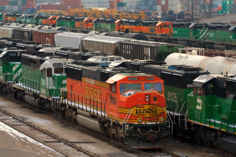 an assortment of different colored railroad engines and cars