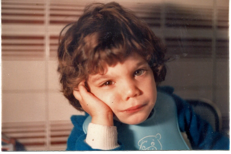 a  poses for the camera wearing a blue bib