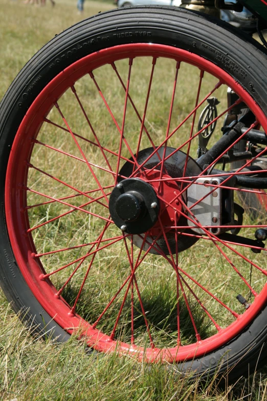a motorcycle wheel and spokes displayed in the grass