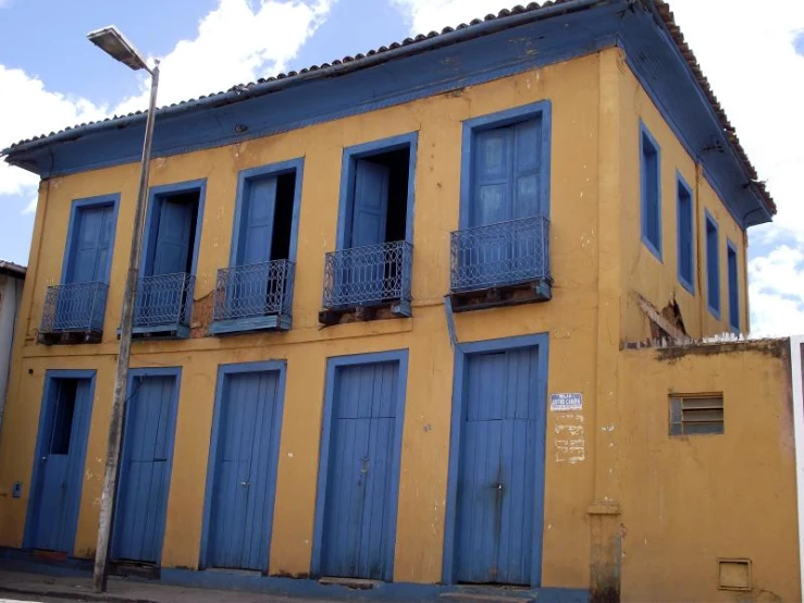 blue and yellow buildings line the street side